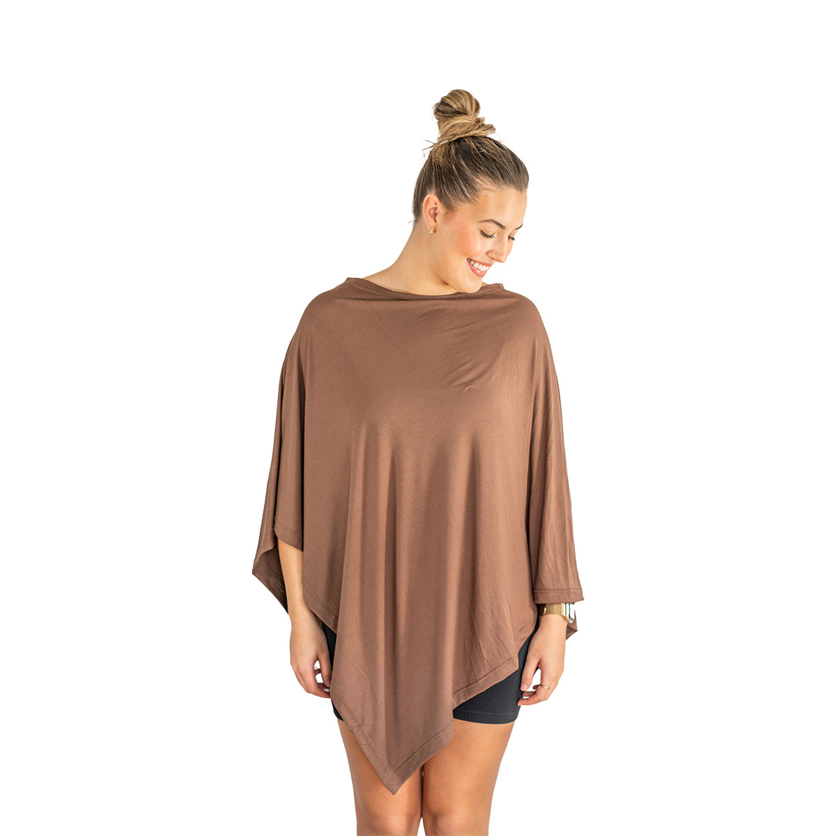 Woman wearing a brown poncho on a white background