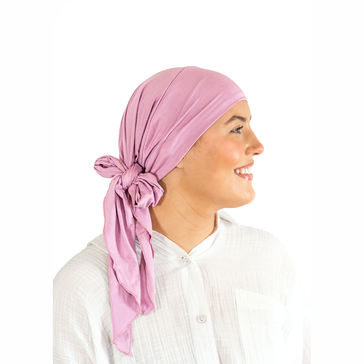 Woman wearing a pink headscarf on a white background