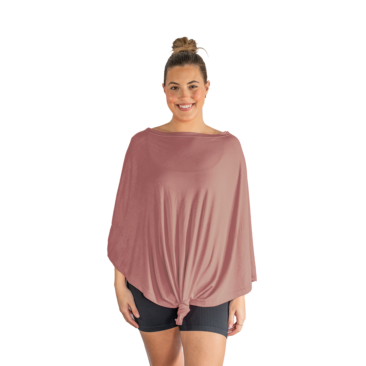 Woman wearing a loose-fitting pink top and black shorts on a white background