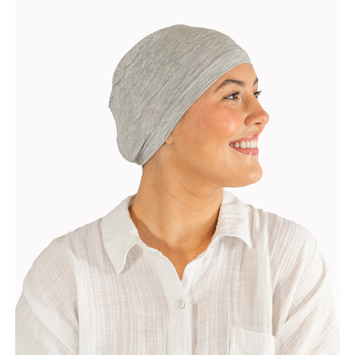 Woman wearing a gray headscarf and white shirt on a white background