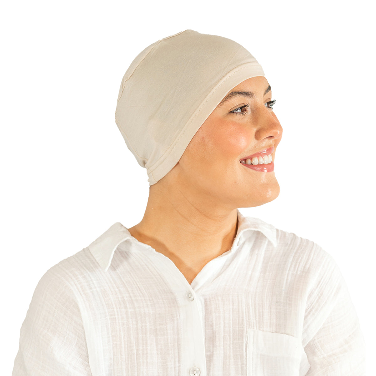 Woman wearing a beige headscarf and white shirt on a white background