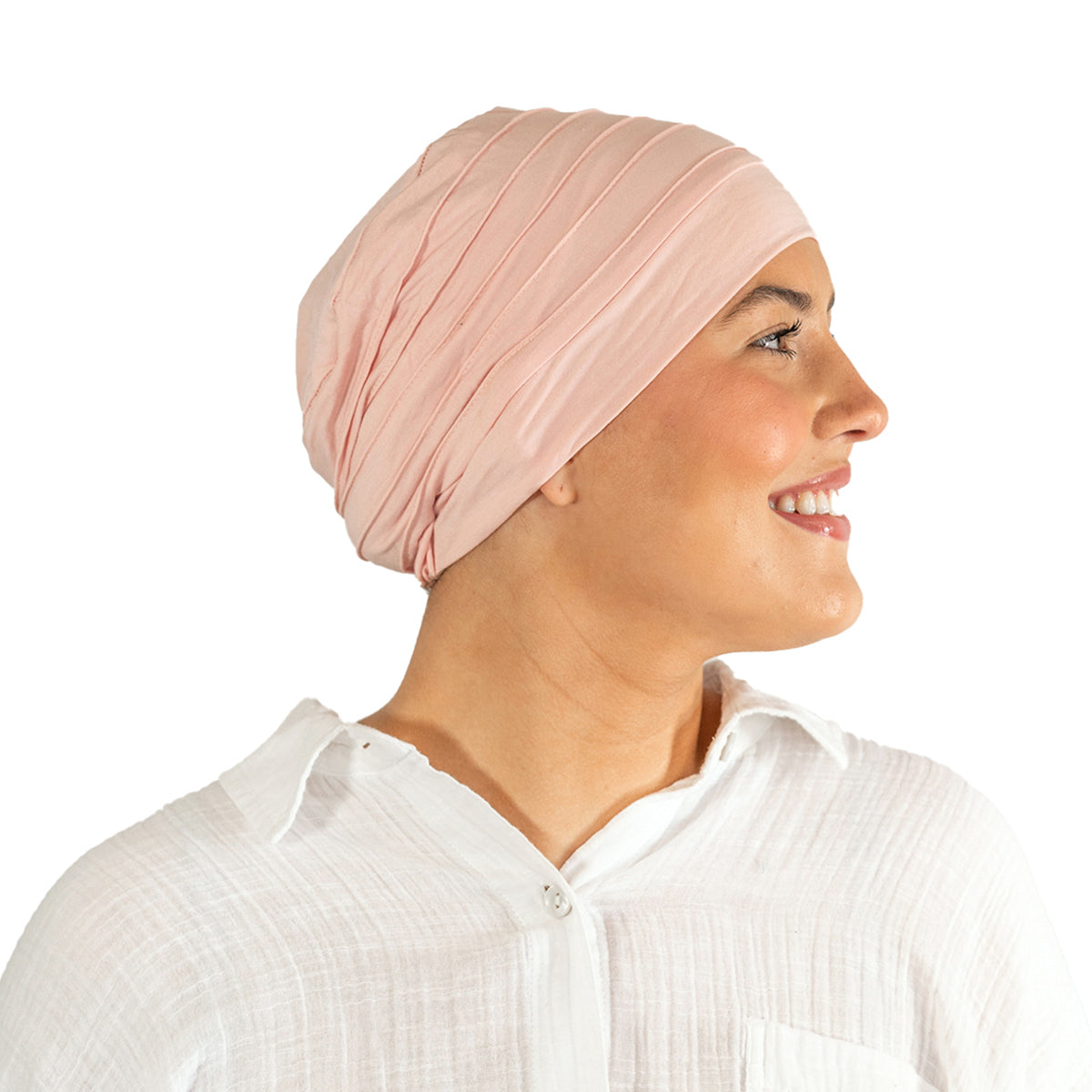 Woman wearing a light pink turban on a white background