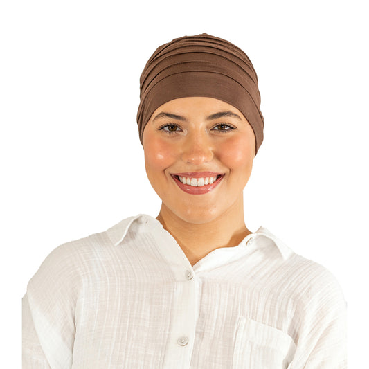 Woman wearing a brown headscarf on a white background