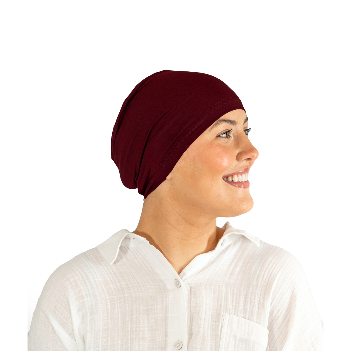 Person wearing a burgundy headscarf and white shirt on a white background