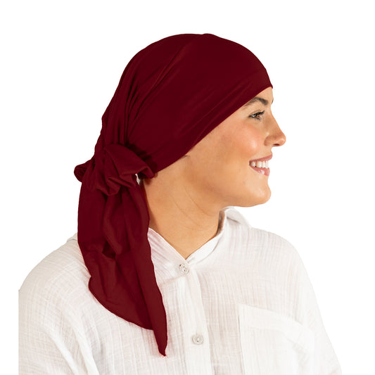 Woman wearing a red headscarf on a white background