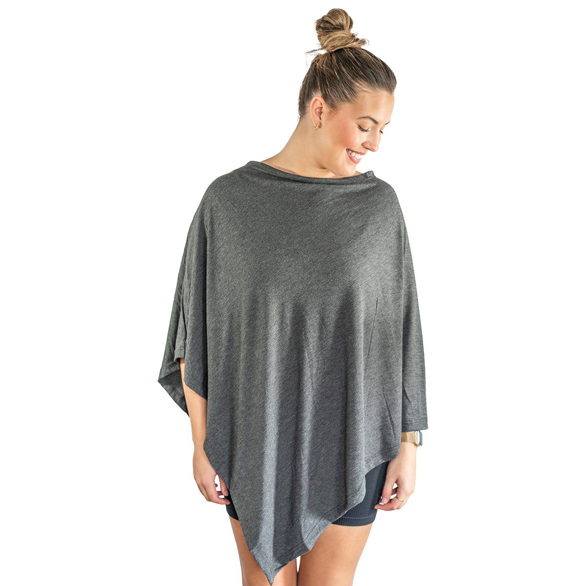 Woman wearing a gray poncho on a white background