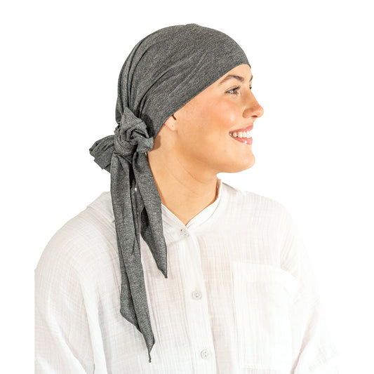 Person wearing a gray headscarf on a white background