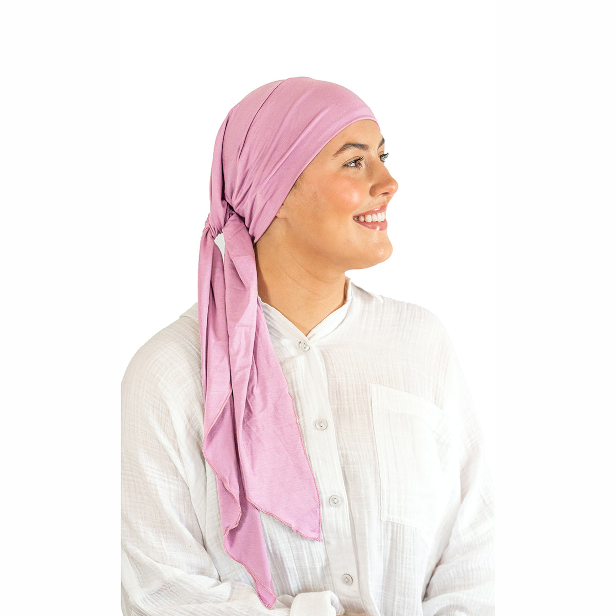 Woman wearing a pink headscarf on a white background