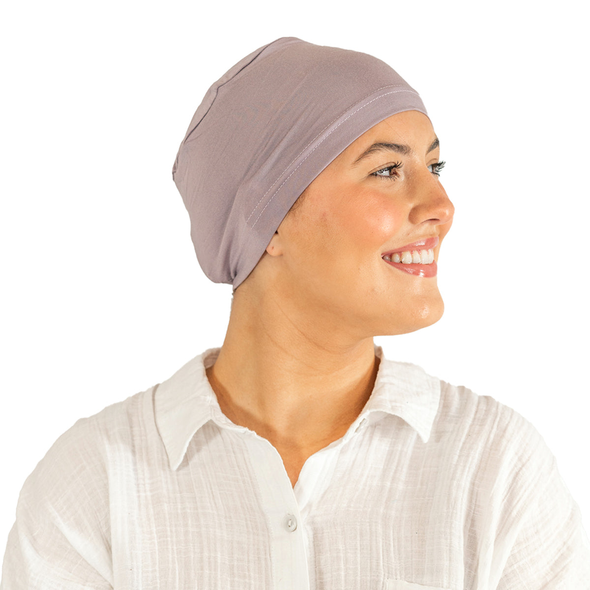 Woman wearing a beige headscarf on a white background