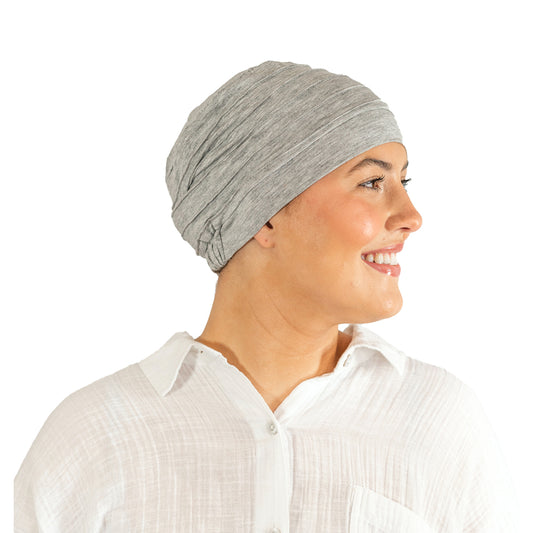 Woman wearing a gray headscarf on a white background
