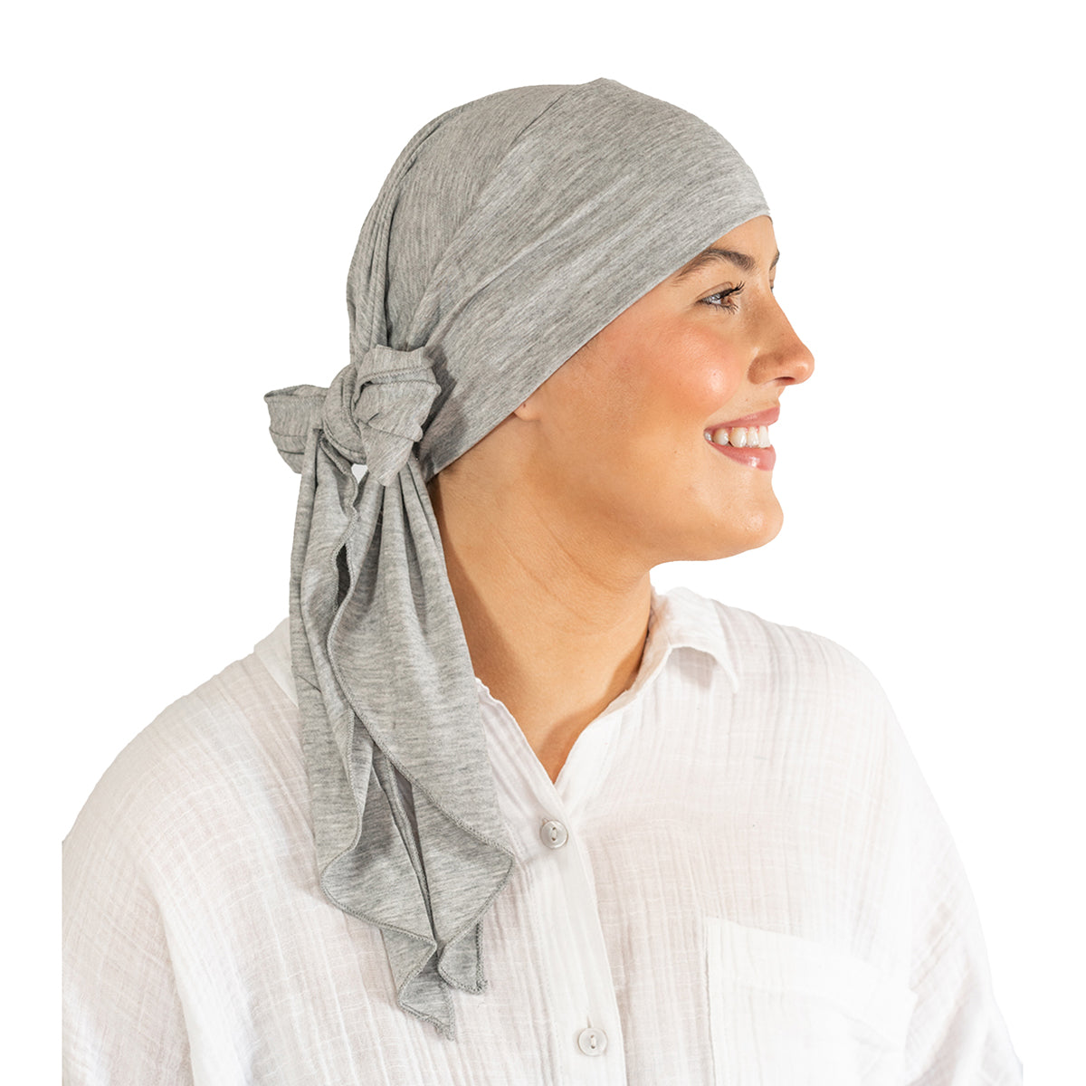 Woman wearing a gray headscarf with a bow on a white background