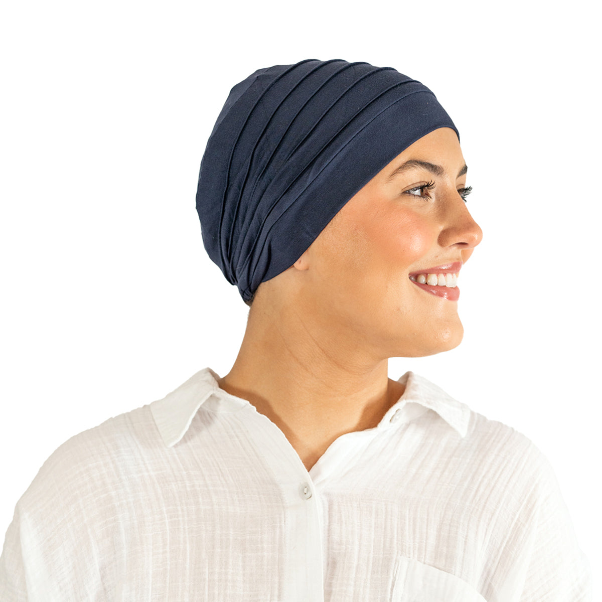 Woman wearing a navy blue headscarf on a white background