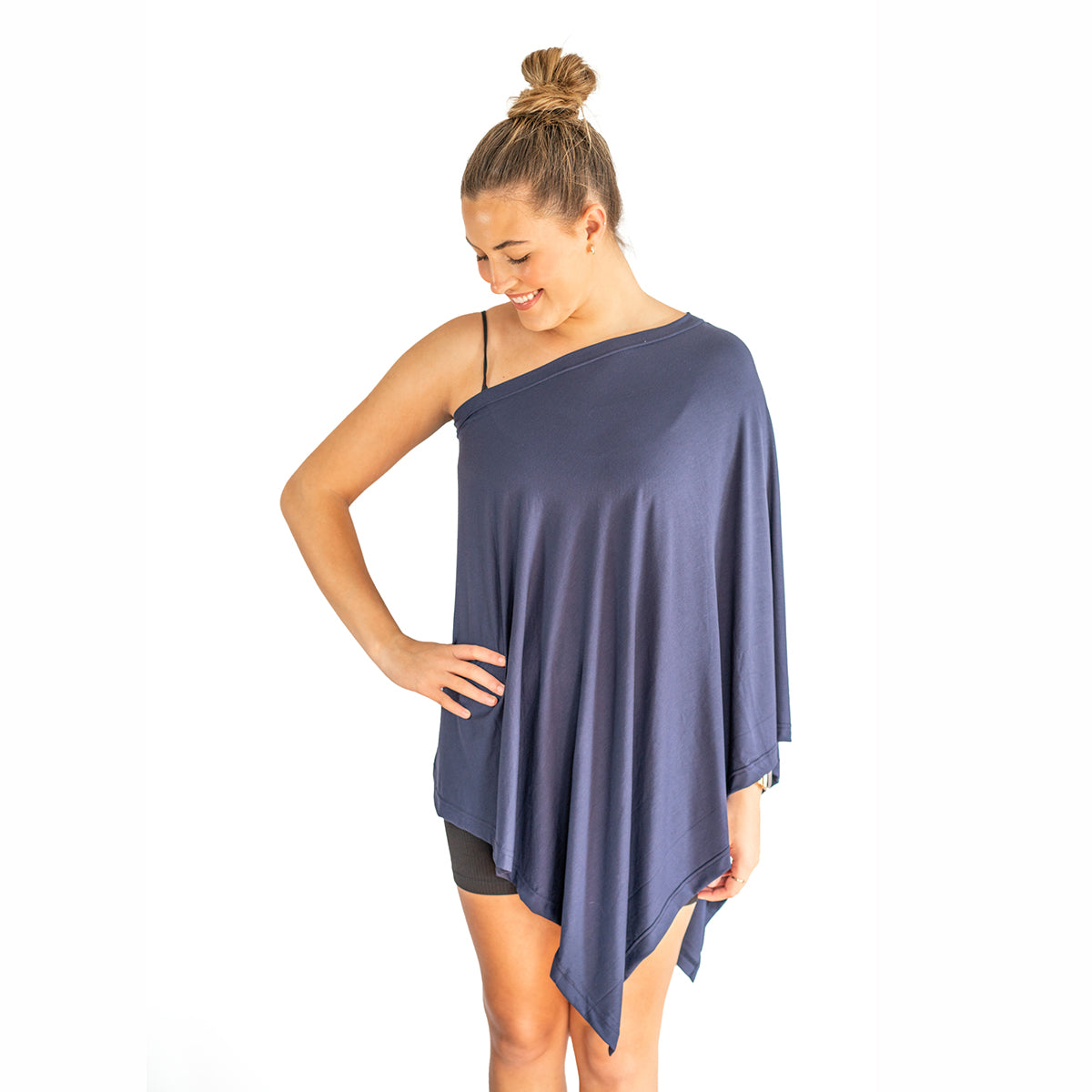 Woman wearing a blue one-shoulder top on a white background