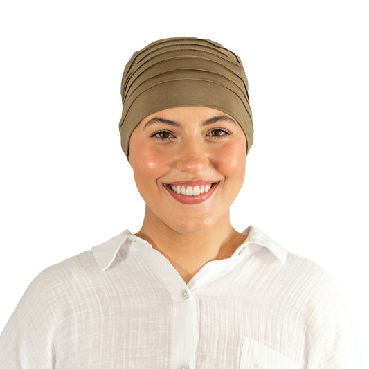 Woman wearing a beige headscarf on a white background
