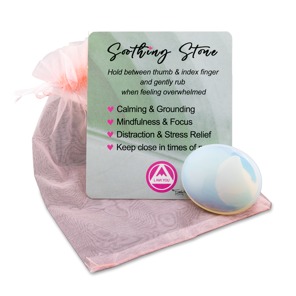 Soothing stone with a card explaining its benefits on a pink fabric background