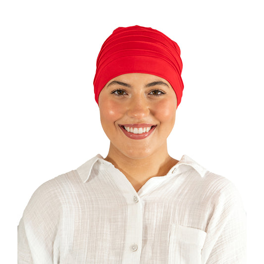 Person wearing a red headscarf and white shirt on a white background