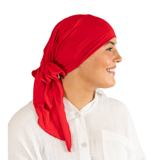 Woman wearing a red headscarf on a white background