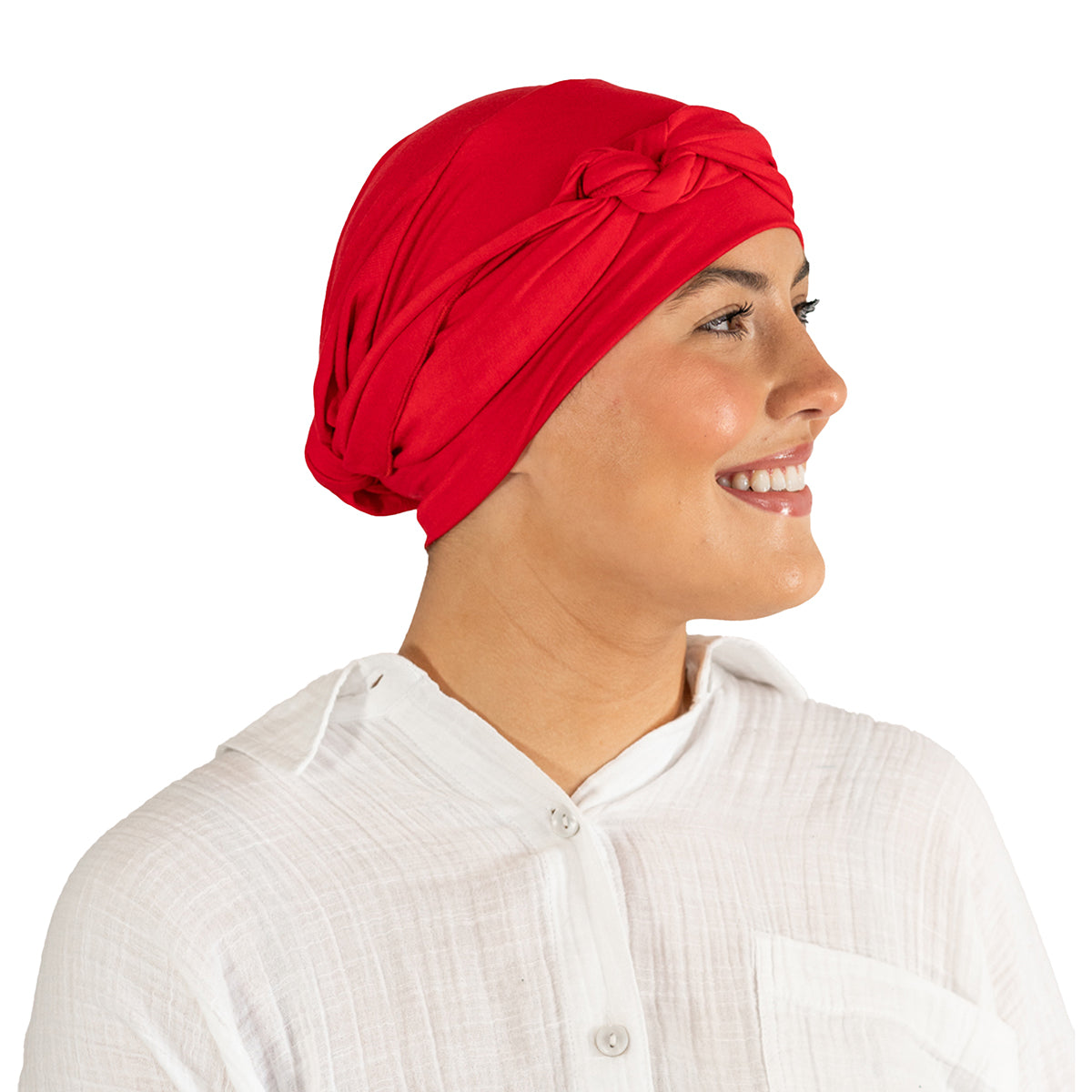 Woman wearing a red headscarf and white shirt on a white background