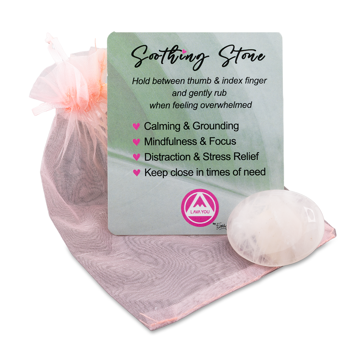 Soothing stone with a card explaining its benefits on a pink fabric background