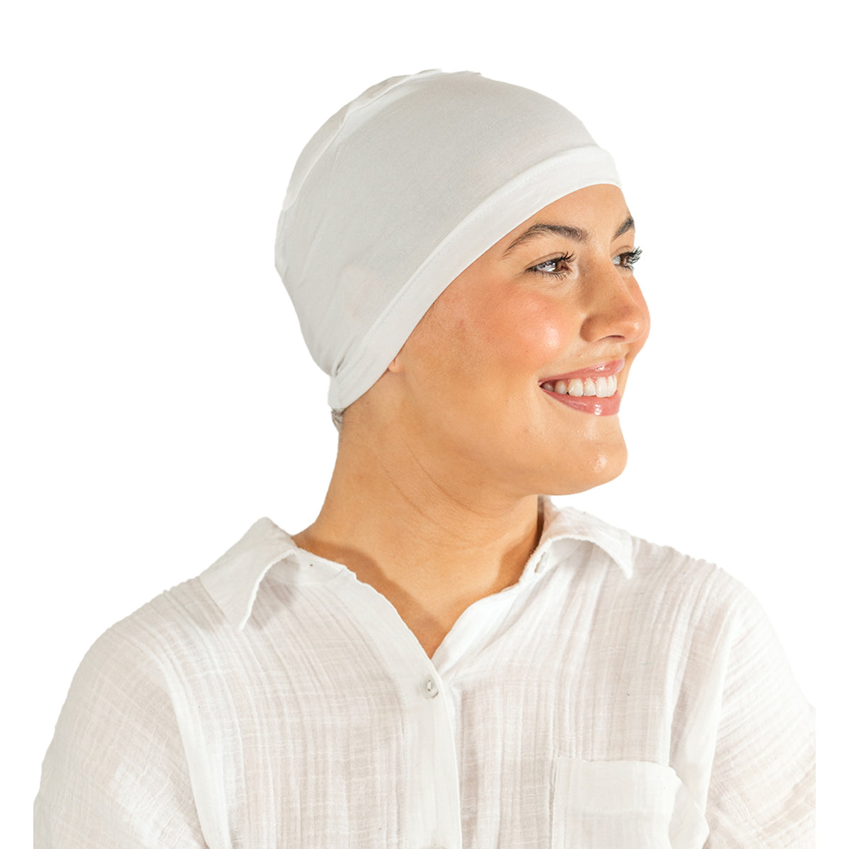 Woman wearing a white headscarf and white shirt on a white background