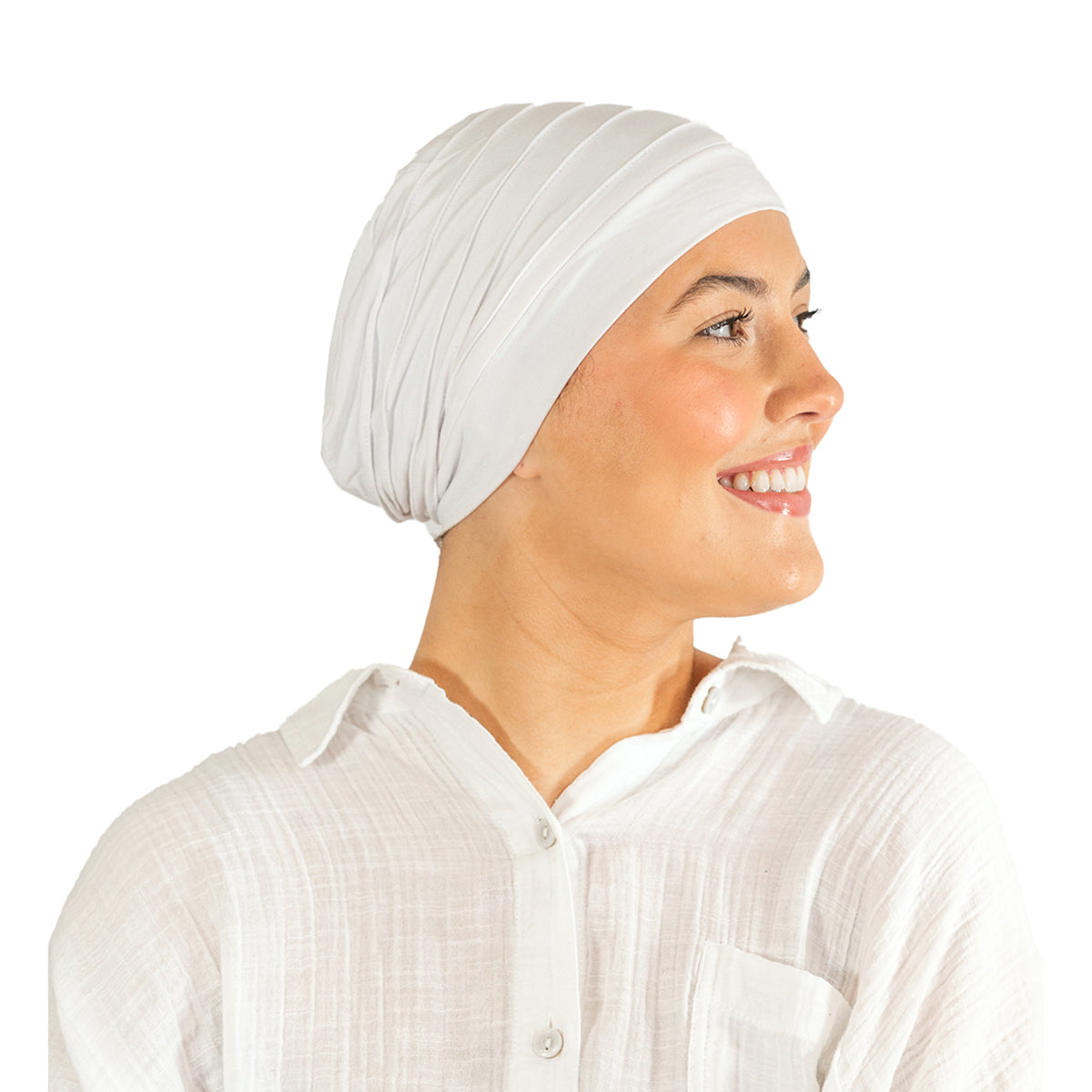 Woman wearing a white turban and white shirt on a white background