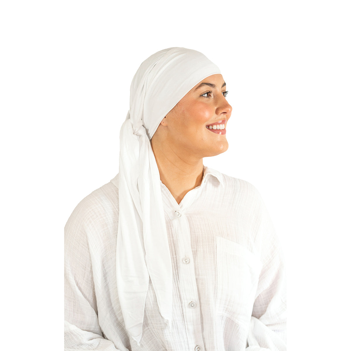 Woman wearing a white headscarf and white shirt on a white background