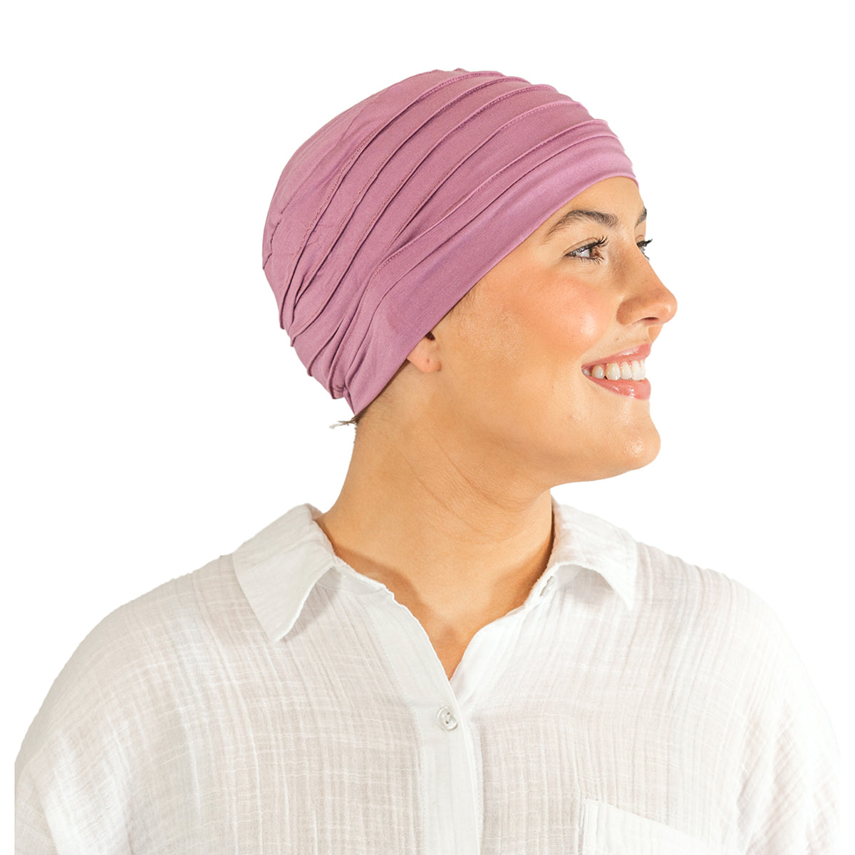 Woman wearing a pink headscarf and white shirt on a white background