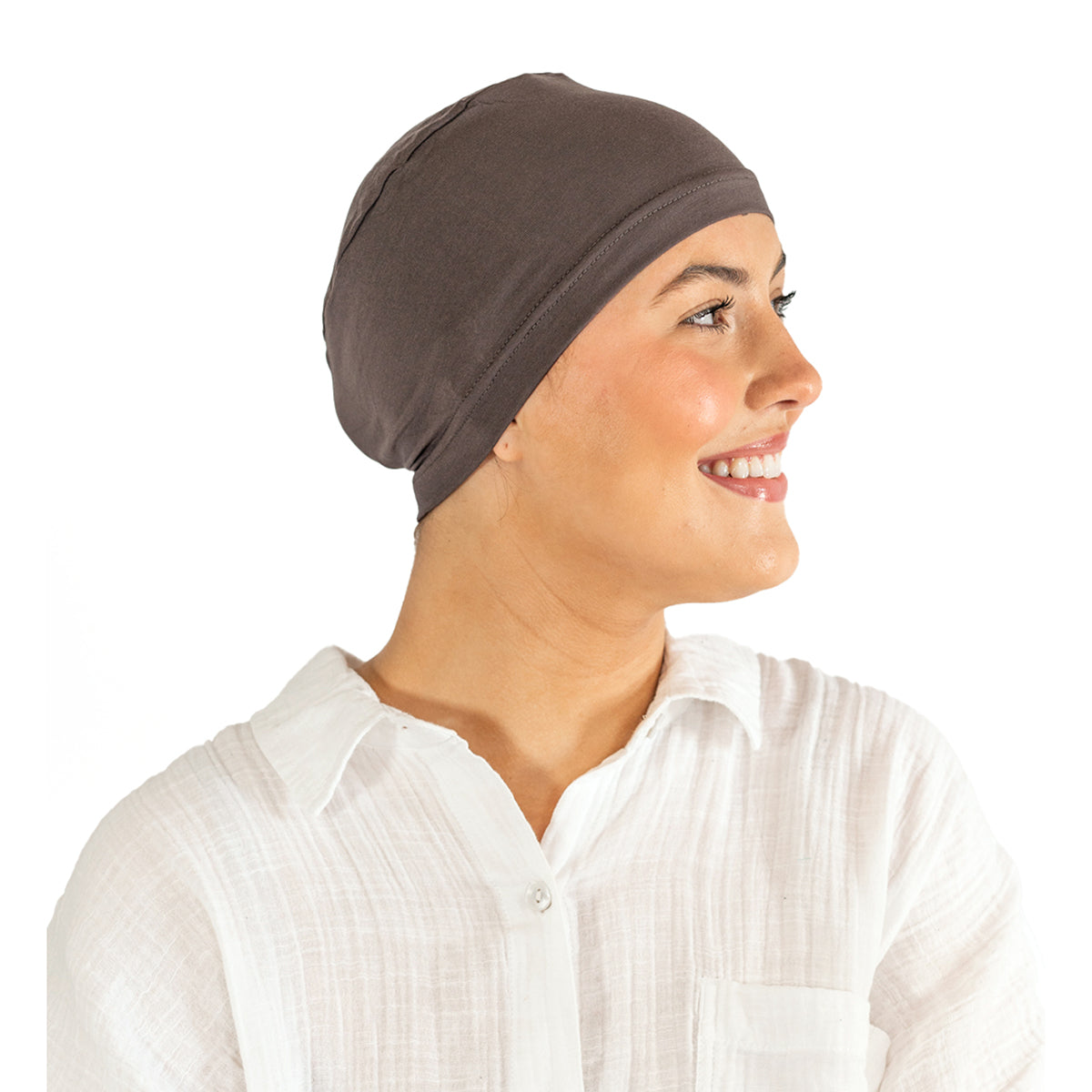 Woman wearing a brown headscarf and white shirt on a white background