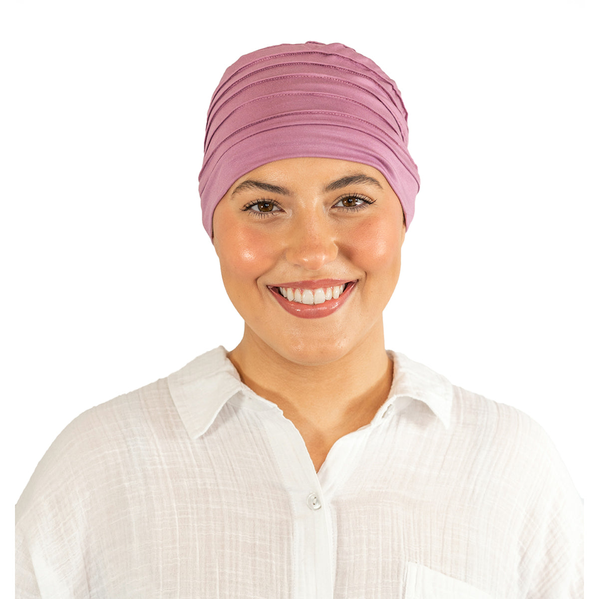 Woman wearing a pink headscarf on a white background